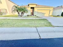Charming single-story home featuring a well-manicured lawn and vibrant tropical landscaping at 3082 Royal Tern Dr, Winter Haven, FL 33881