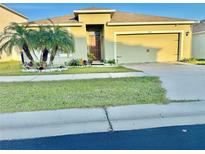 Charming single-story home featuring a well-manicured lawn and vibrant tropical landscaping at 3082 Royal Tern Dr, Winter Haven, FL 33881