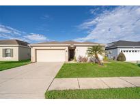 Charming single-story home with well-maintained lawn, mature landscaping, and a two-car garage at 579 Lucerne Blvd, Winter Haven, FL 33881