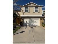 Two story home with two-car garage and neutral toned exterior, perfect for any buyer at 3555 Rodrick Cir, Orlando, FL 32824