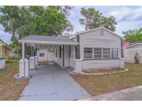 Charming home featuring a carport, well-maintained lawn, and classic siding at 406 10Th St, St Cloud, FL 34769