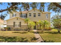 Charming two-story home with lush landscaping and a welcoming walkway at 4061 Flowering Peach Ln, St Cloud, FL 34772