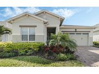 Charming single-Gathering home featuring a well-manicured lawn and a two-car garage on a sunny day at 5151 Twin Lakes Blvd, St Cloud, FL 34772