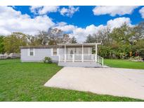 Charming single-story home with a covered front porch and well-maintained lawn at 790 Park Ln, Kissimmee, FL 34741