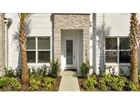 Charming two-story home featuring stacked stone accents and manicured landscaping at 17238 Blessing Dr, Clermont, FL 34714