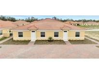 Charming, newly built duplex featuring brick paved driveway and a vibrant, classic Spanish-tile roof at 1785 Coriander Dr, Kissimmee, FL 34759