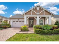 Charming single-Gathering home showcasing a well-manicured lawn and inviting brick pathway at 2460 Promenade Dr, St Cloud, FL 34772