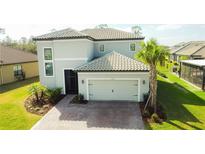 Charming two-story home featuring a two-car garage, neutral paint, tile roof, and well-manicured landscaping at 3920 Reed Grass Pl, Kissimmee, FL 34746
