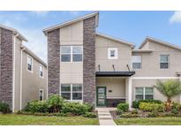 Charming two-story home with stone accents, inviting entrance, and well-maintained landscaping, offering curb appeal at 978 Splash Shot Pl, Davenport, FL 33896