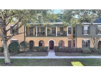 Charming townhome with a covered front porch and a well-maintained landscaped yard at 1000 Via Capri Ln # 103, Kissimmee, FL 34747