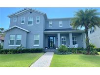 Stunning two-story home featuring a paved walkway, lush landscaping, and inviting front porch at 13173 Lower Harden Ave, Orlando, FL 32827