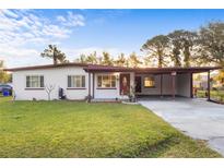Charming single-story home featuring a covered carport and well-maintained front yard at 204 Marion Ave, Kissimmee, FL 34741