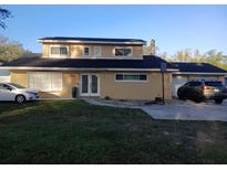 Charming two-story home with well-maintained lawn and a spacious driveway for multiple cars at 2211 New Jersey Rd, Lakeland, FL 33803