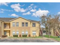 Inviting two-story condo building featuring neutral colors, well-maintained landscaping, and a charming, bright exterior at 2794 Club Cortile Cir # B, Kissimmee, FL 34746