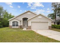 Charming single-story home featuring a two-car garage and well-maintained lawn at 3193 Verbena Ct, Deltona, FL 32725
