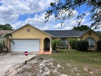 Charming one-story home featuring a two-car garage and a well-maintained lawn at 326 Hanging Moss Rd, Davenport, FL 33837
