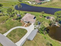 Stunning aerial view of a lakeside property with lush landscaping and a private gazebo at 3607 Hidden River Ln, Tavares, FL 32778