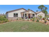 Charming single-story home with well-manicured lawn, tasteful landscaping, and a welcoming front porch at 3607 Hidden River Ln, Tavares, FL 32778