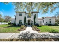 Stunning two-story home with a beautiful front yard, pathway, and architectural details at 808 Golfpark Dr, Celebration, FL 34747