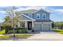 Charming two-story home featuring a 2 car garage and manicured landscaping at 11354 History Ave, Orlando, FL 32832