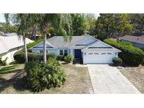 Charming single-story home featuring a well-manicured lawn and an attached two-car garage at 129 Pine Lake View Dr, Davenport, FL 33837