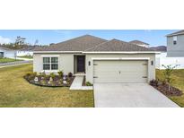 Charming single-story home with a well-maintained lawn and a two-car garage at 202 Zircon Rd, Kissimmee, FL 34758