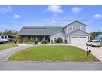 Charming two-story home with landscaped yard, solar panels, and circular driveway on a sunny day at 2086 Blackfoot Trl, St Cloud, FL 34771