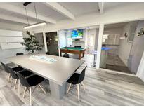 Spacious recreation room with a pool table, large table, and adjacent bar for endless entertainment possibilities at 2326 S Peninsula Dr, Daytona Beach, FL 32118
