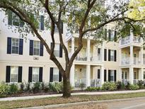 Elegant condo building featuring classic architectural details, manicured landscaping, and inviting balconies at 910 Spring Park St # 103, Celebration, FL 34747