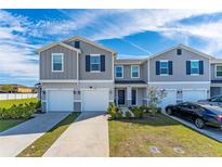 Charming townhome features a well-manicured lawn and inviting front entrances at 1536 Mirabella Cir, Davenport, FL 33897
