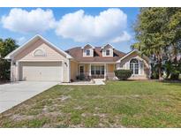 Charming single-Gathering home with a two-car garage and well-maintained front yard at 1916 Nicholas Pl, St Cloud, FL 34771