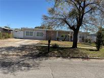 Charming single-story home featuring well-maintained landscaping and a spacious front yard at 1937 Barksdale Dr, Orlando, FL 32822