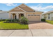 Charming one-story home featuring a two-car garage, paver driveway, and well-manicured landscaping at 2658 Meadowedge Loop, St Cloud, FL 34772