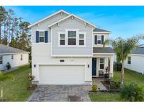 Beautiful two-story home featuring a two-car garage and lush landscaping for curb appeal at 2724 Camden Ln, Davenport, FL 33837