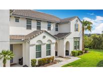 Beautiful townhouse exterior with a well maintained lawn, tasteful landscaping, and neutral color scheme at 426 Captiva Dr, Davenport, FL 33896