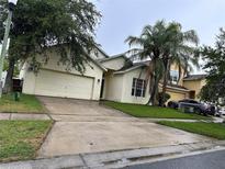 Charming single-Gathering home with a well-maintained lawn and a two-car garage at 4406 Hidden Meadow Dr, Kissimmee, FL 34746