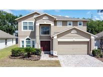 Charming two-story home featuring a brick paver driveway, a two-car garage, and a well-manicured front yard at 532 Kildrummy Dr, Davenport, FL 33896