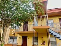 Two-story condo featuring a balcony and outdoor staircase at 731 Wyman Ct # 731-A, Orlando, FL 32809