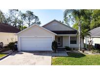 Charming single-story home featuring a two-car garage and inviting curb appeal with mature landscaping at 2316 Paulette Dr, Haines City, FL 33844