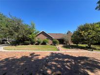Lovely brick home with mature trees and landscaping creating curb appeal at 3725 Blossom St, Kissimmee, FL 34746