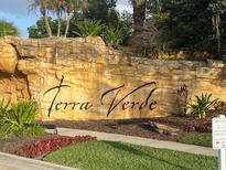 Terra Verde's entrance sign with beautiful stonework and landscaping at 4726 Ormond Beach Way, Kissimmee, FL 34746