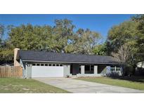 Charming single-story home featuring an attached two car garage and well-maintained lawn at 876 Lobster Ct, Kissimmee, FL 34744