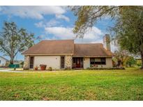 Charming single-story home with a well-maintained lawn and a cozy front porch at 9916 Jackson Rd, Leesburg, FL 34788