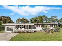 Charming single-story home with a welcoming front porch and well-maintained lawn at 1622 Marlin St, St Cloud, FL 34771