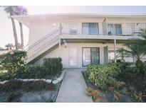 Charming condo with white exterior, balcony, and well-maintained landscaping at 1935 Conway Rd # R4, Orlando, FL 32812