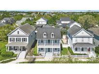 Charming two-story home with a welcoming front porch, white picket fence, and well-manicured lawn at 205 Norfolk Pl, Celebration, FL 34747