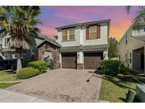 Charming two-story home featuring a beautiful brick paver driveway and a two-car garage at 2755 Monticello Way, Kissimmee, FL 34741