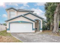 Inviting two-story home with a two-car garage and manicured landscaping at 3007 Bransbury Ct, Kissimmee, FL 34747