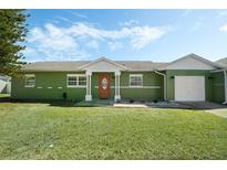 Charming single-story home with a well-manicured lawn and inviting front porch under a partly cloudy sky at 3030 Little Sound Dr, Orlando, FL 32827