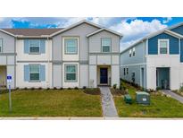Charming townhome with a well-manicured lawn and welcoming entrance showcases the exterior of the home at 4002 Lana Ave, Davenport, FL 33897